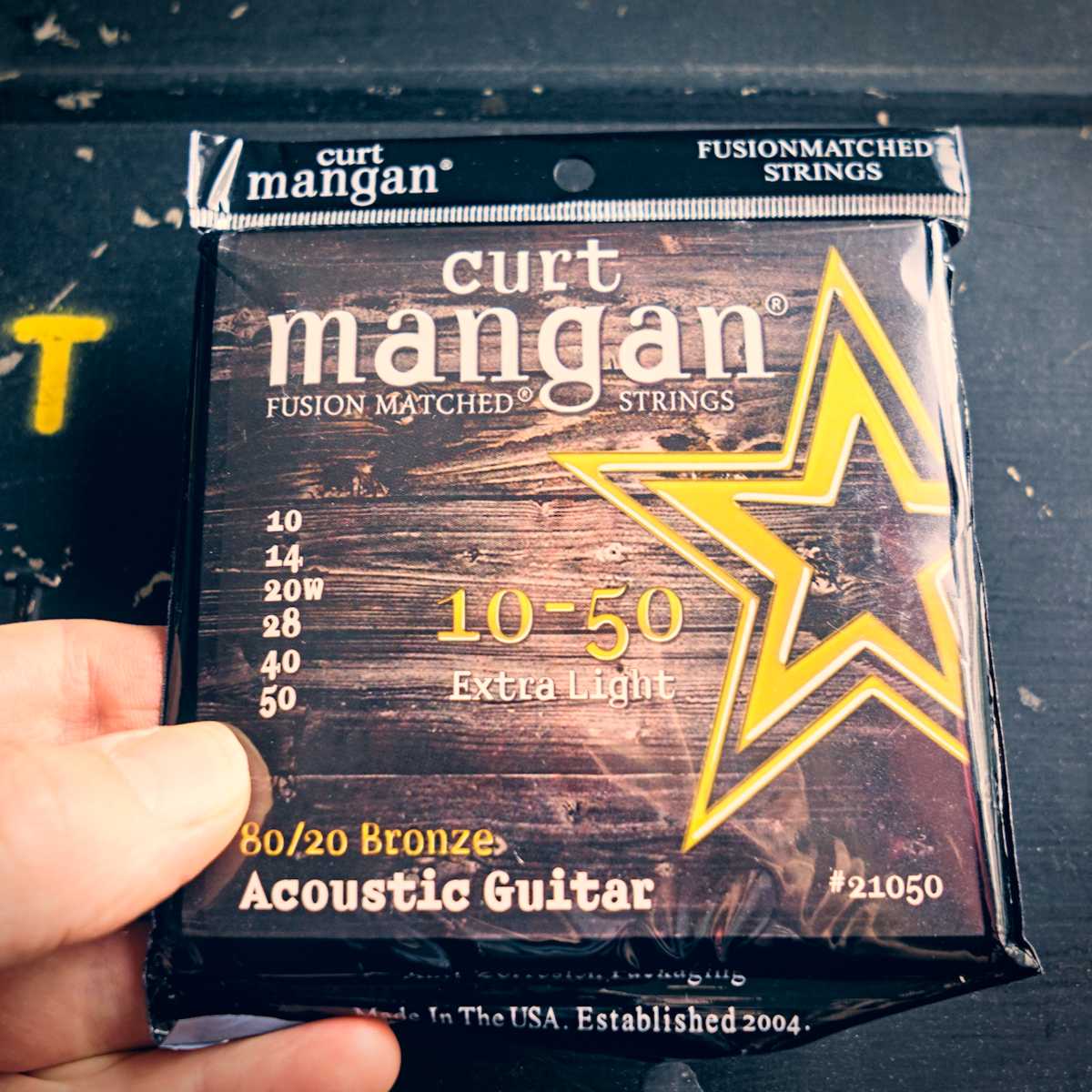 A set of Curt Mangan 80/20 acoustic guitar strings for fingerstyle guitar