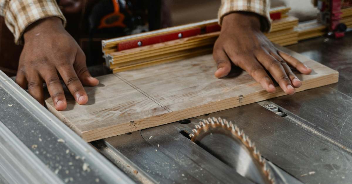 A luthier cutting a block of wood with a circular saw