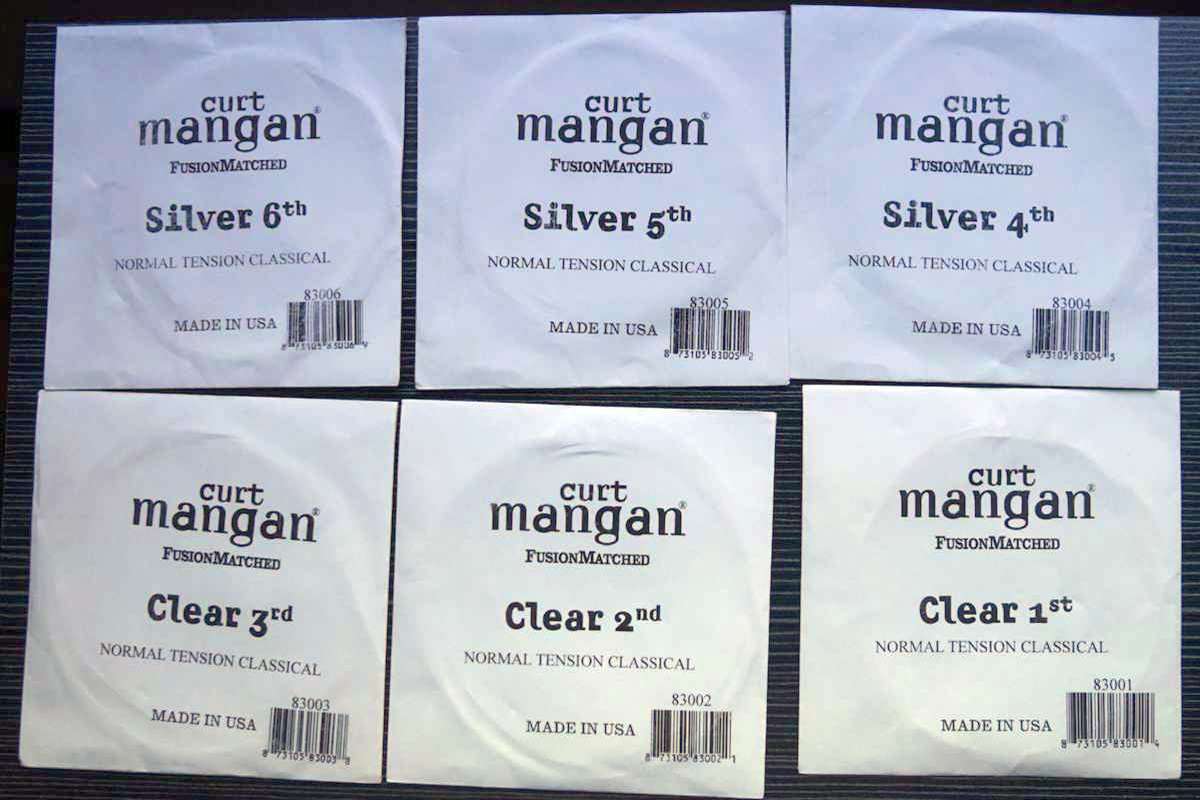 A set of Curt Mangan nylon strings individually packaged, showing strings 1 to 6 and their material
