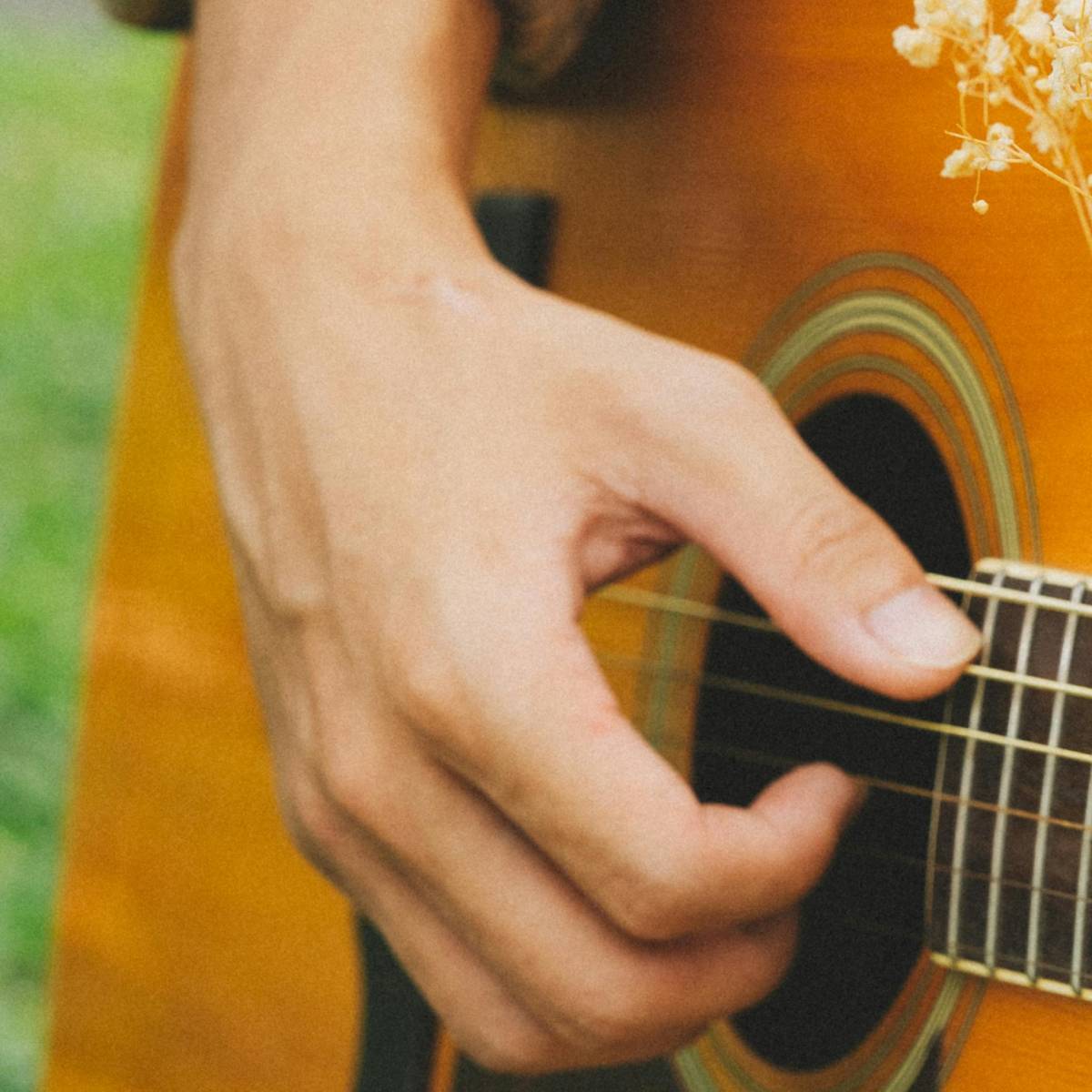 Hand playing fingerstyle guitar