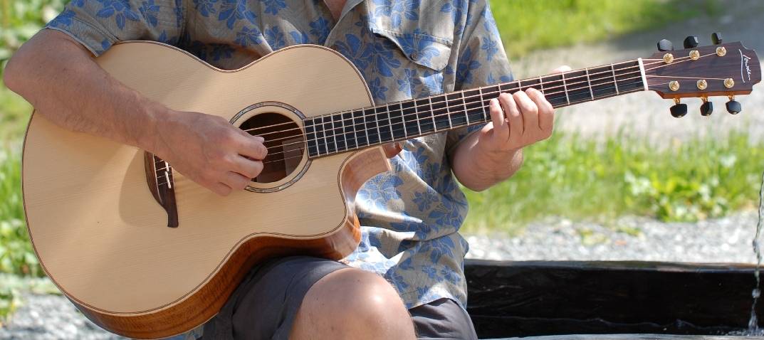 George Lowden playing one of his guitars